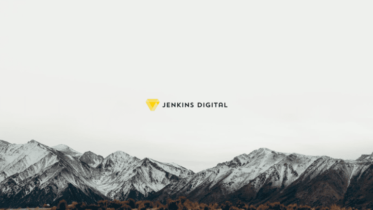 Mountain range with grey sky and the Jenkins Digital logo centre.